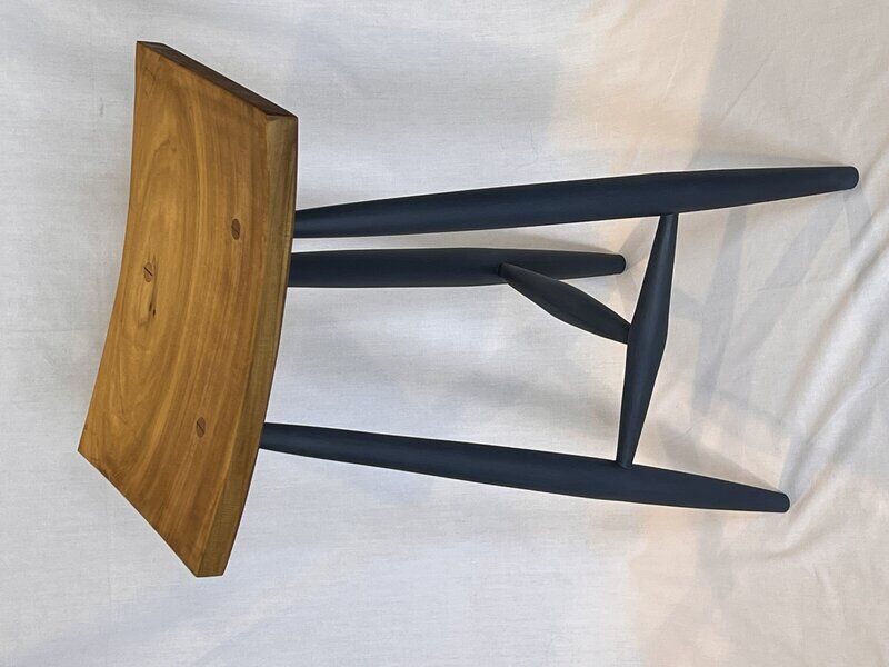 Three-legged stool with hand-shaped poplar seat and turned maple legs, finished in deep sapphire milk paint and shellac